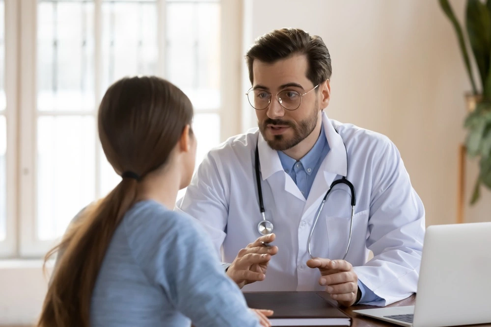 A doctor in Texas converses with a patient, clarifying the complexities of responsibility in medical malpractice cases