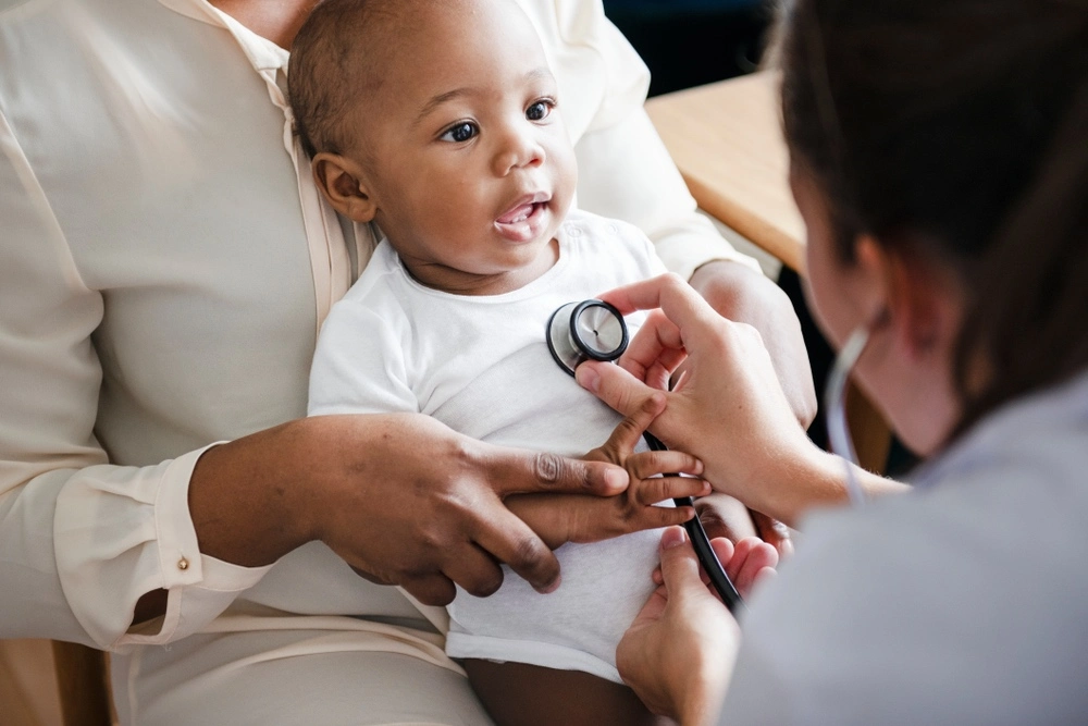 In a Texas hospital, a newborn child is meticulously examined by a doctor for any signs of birth injuries, highlighting the crucial early detection process