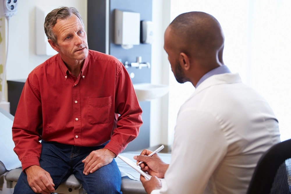 A doctor engages in a serious conversation with a patient, embodying the pivotal role of witness testimony in medical malpractice cases