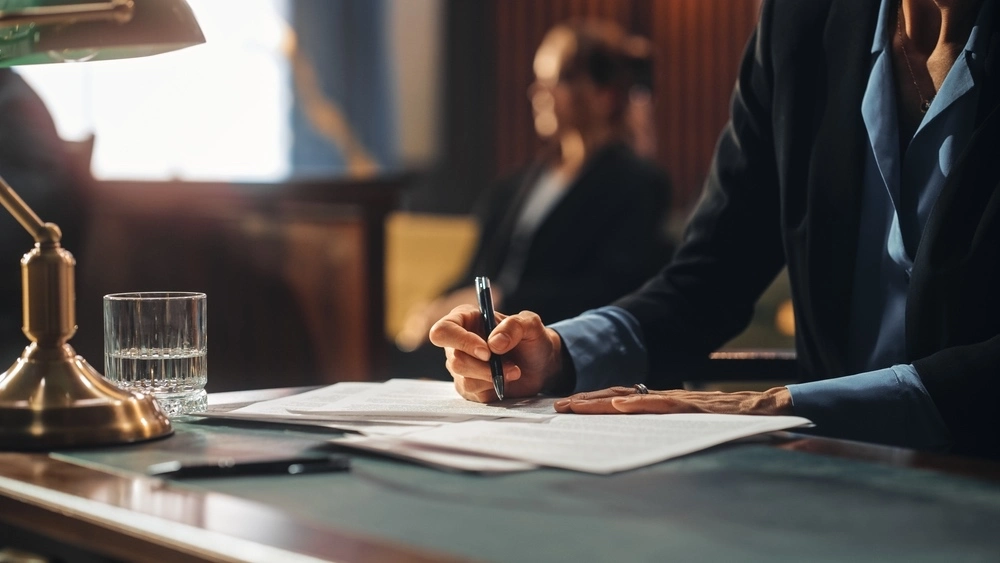 In a Texas courtroom, a female client sits beside her birth injury attorney, ready to present their case