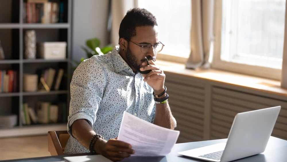 A concerned individual pores over documents, learning about the various types of damages defined under Personal Injury Law in Baltimore, Maryland