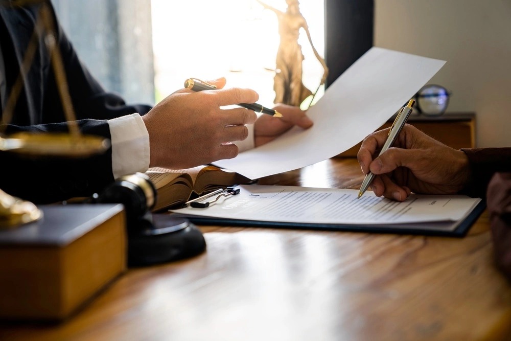 A client discusses the details of suing for negligence with a medical malpractice lawyer in a Texas law office, seeking justice and accountability