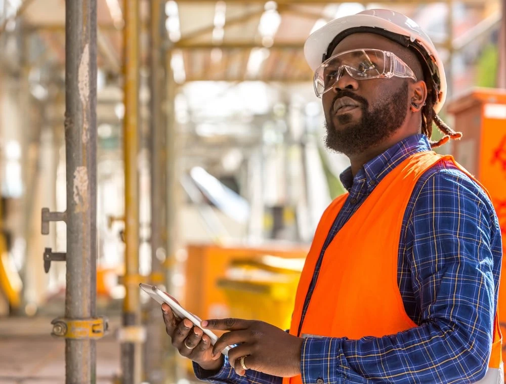 A worried worker scans the perilously unsafe working conditions around him, foreseeing the potential for personal injury among his colleagues in Baltimore